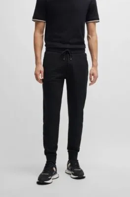Pantalones de chándal en felpa de algodón con logo estampado en goma