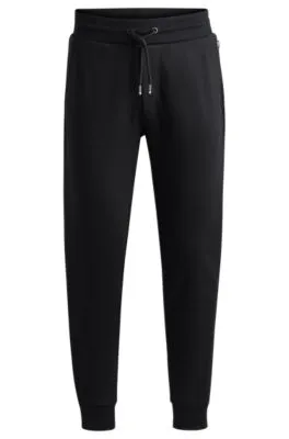 Pantalones de chándal en felpa de algodón con logo estampado en goma