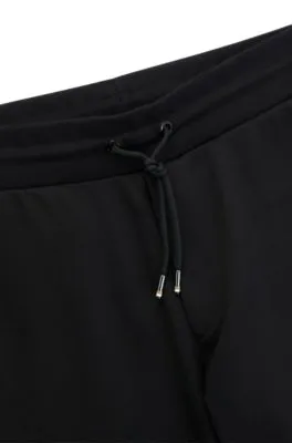 Pantalones de chándal en felpa de algodón con logo estampado en goma